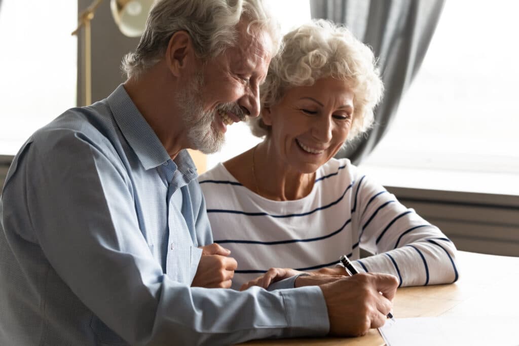 Satisfied senior couple signing agreement buying medical health insurance